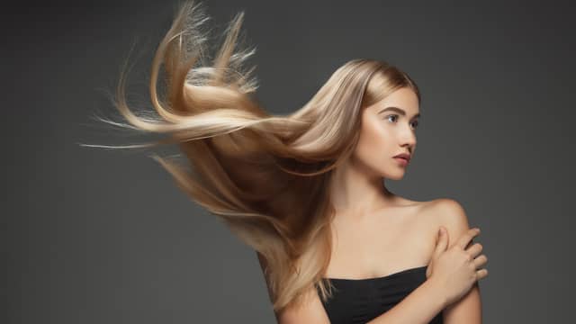 Professional balayage hair transformation showing natural-looking highlights and color depth